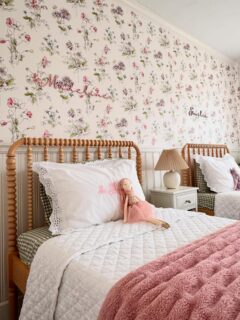 In honor of my twins’ room being clean for all of five minutes, I figured it was the perfect time to finally take some photos 🌸

I love this wallpaper so much...I spotted it at Brimfield last year and knew I needed it. We added half-wall beadboard and paired it with spindle beds, which gives the room that extra layer of charm and personality. One girl’s favorite color is pink and the other’s is purple, so the pattern conveniently checked both boxes.

Most days this room is covered in trinkets, stuffed animals, homemade artwork, and tiny treasures taped to the walls (which honestly makes me love it even more). But for the sake of the feed, I went with the more aesthetically pleasing version today😅

And like most homes, there are still things I’d eventually love to update (the carpeting being one of them), but it’s just not a priority right now. The warm neutral rug between the beds helps soften it up in the meantime. If I waited for every space in my house to feel fully finished and perfect before sharing, I’d probably never post any personal content at all 🤍