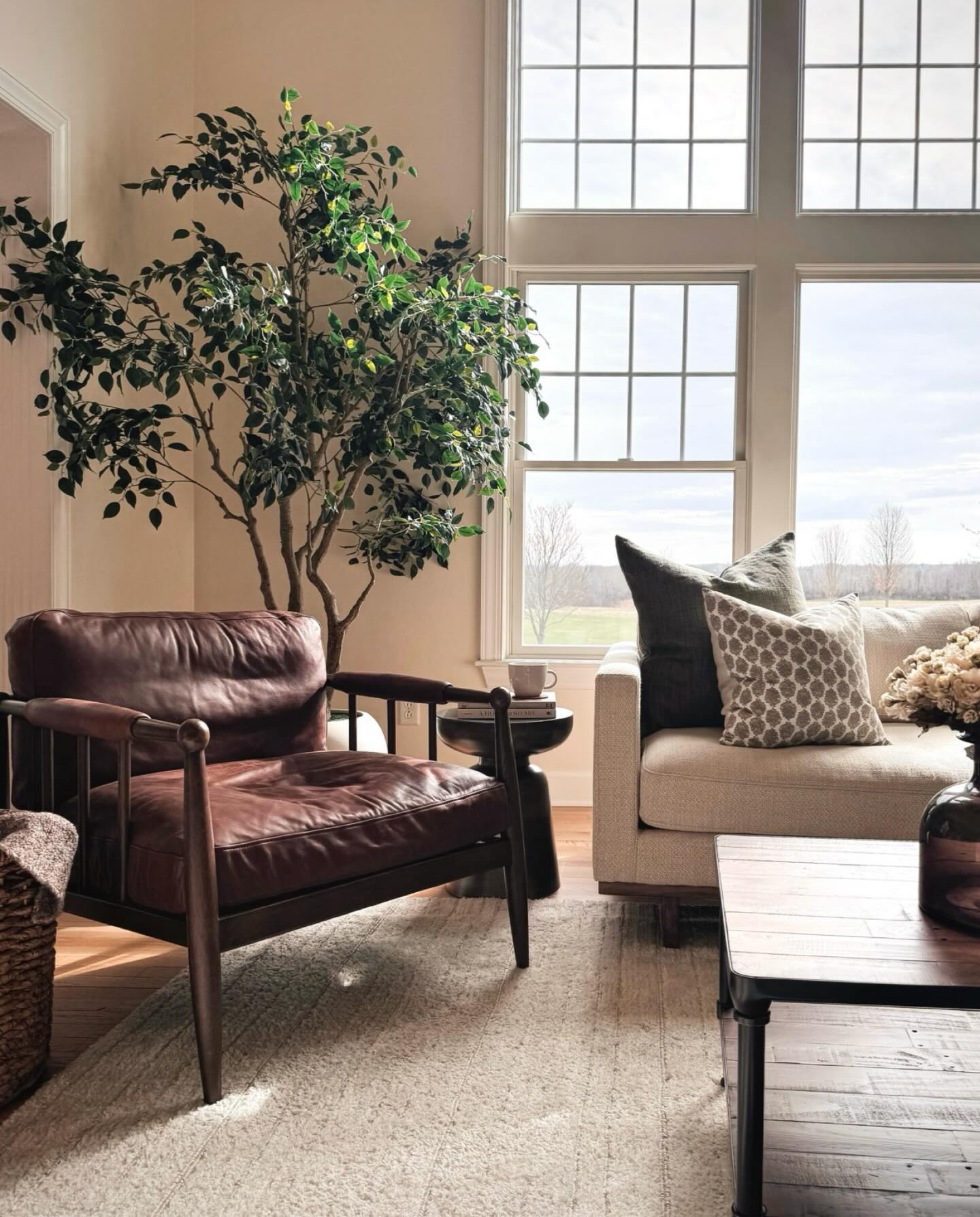 One of my favorite shots from a recent furnishing project. I love this angle because it captures so many materials and textures in one moment: soft linen, textured wool, warm wood, metal and glass accents, greenery, a block-print pattern, and of course some buttery saddle leather…the kind that only gets better with age 😍

This is your sign to mix materials in your home! I’ve found it to be one of the easiest ways to make a room feel warm, layered and complete 🤍